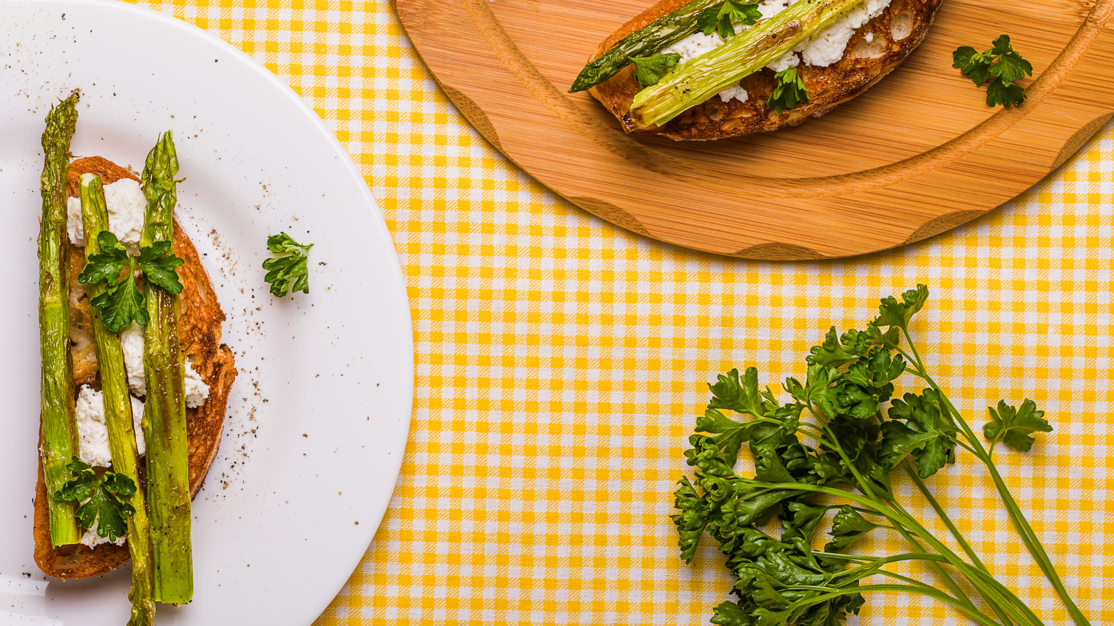 Yellow tablecloth and a plate with roasted asparagus