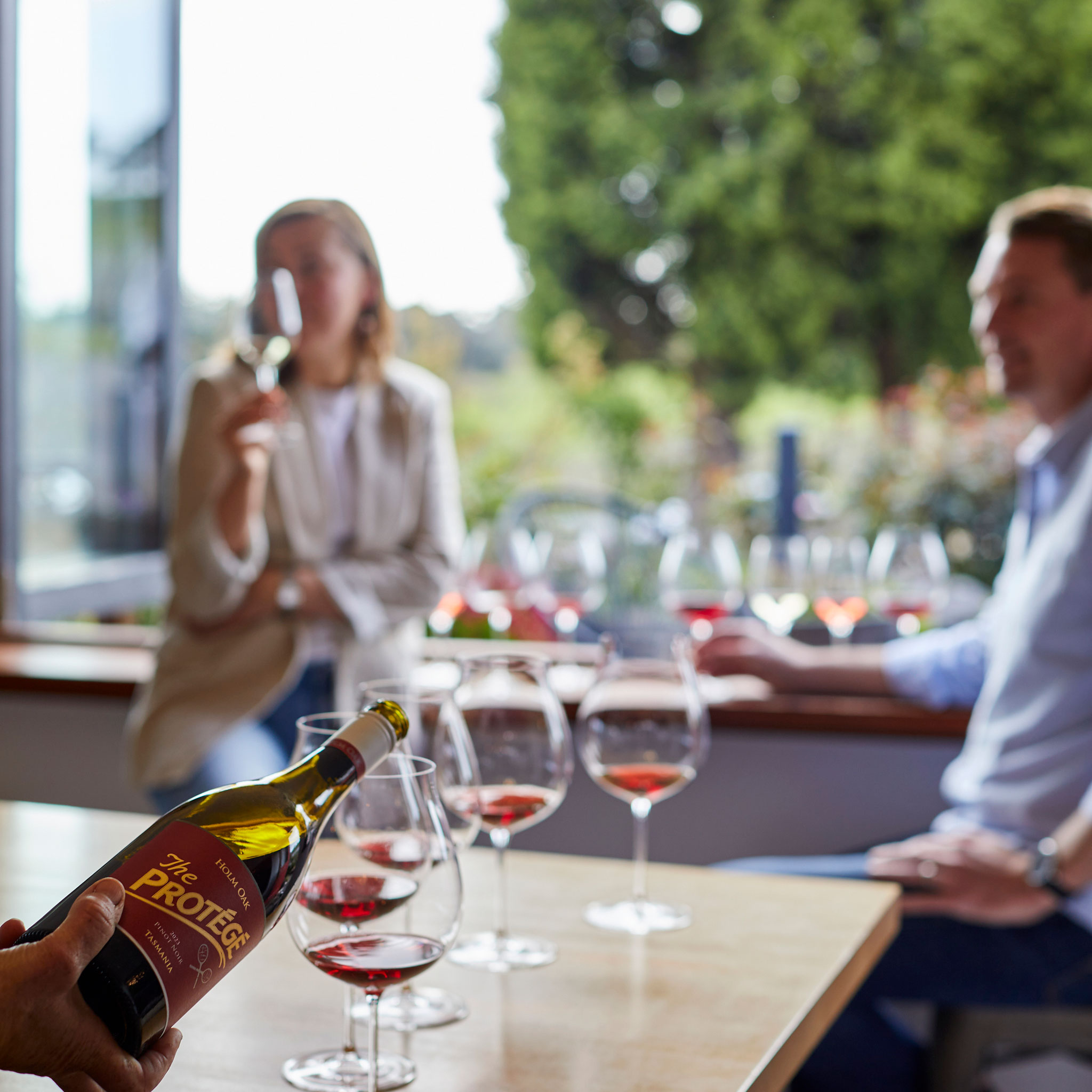 People enjoying the Holm Oak Pinot Noir tasting at Cellar Door